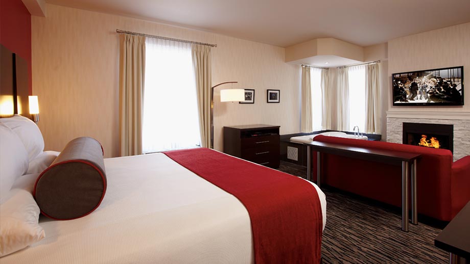 large room at the c hotel in hamilton with king sized bed, whirlpool tub and fireplace