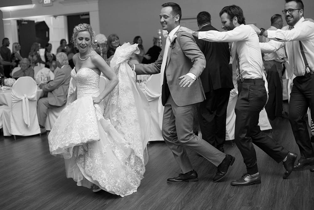 bride and groom doing line dance at wedding