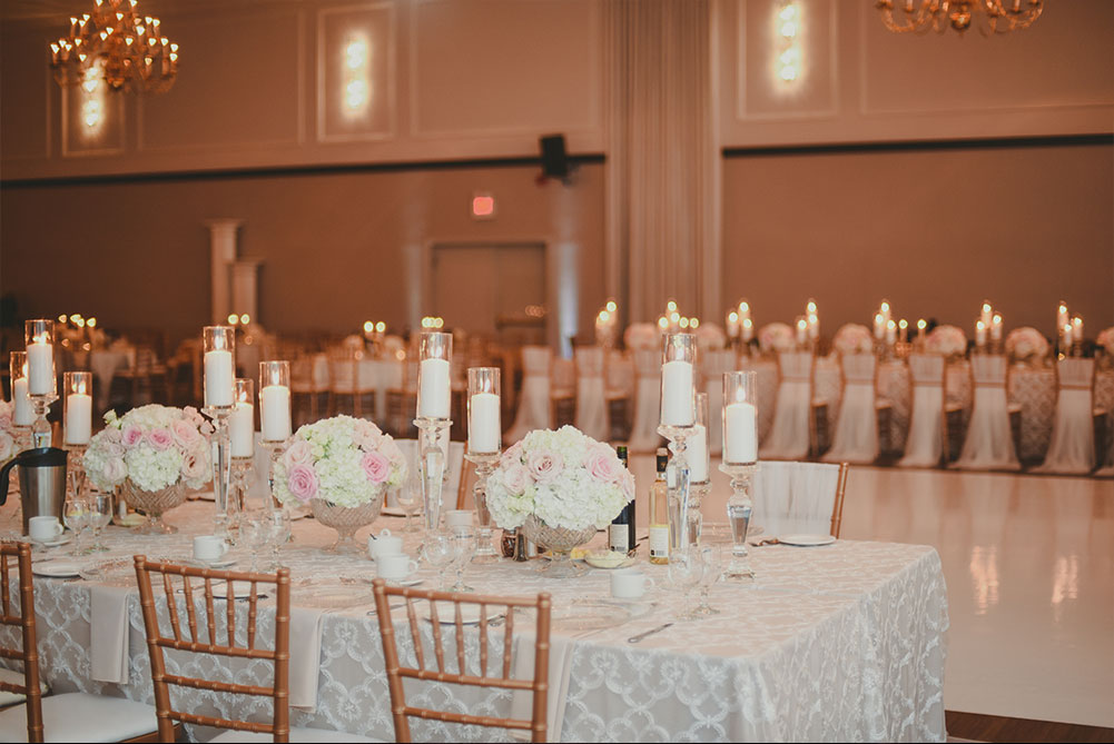 ivory, blush and gold wedding reception decor with floral centerpieces, crystal candle holders and chiavari chairs