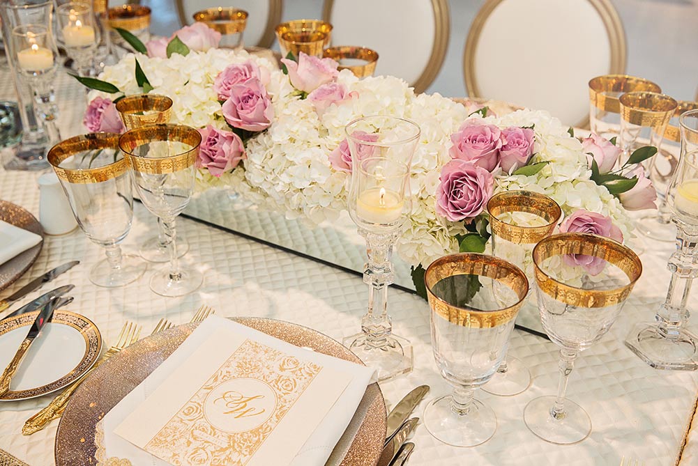 close up of wedding table decor and gold cutlery