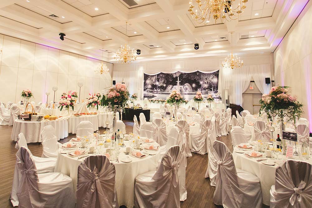 white and pink wedding reception decor with dramatic head table backdrop