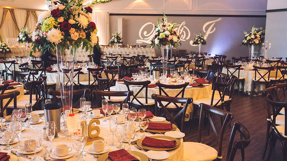 gold and burgundy wedding reception decor with vineyard chairs